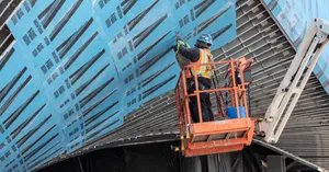 Construction worker working on a facade of a construction project.