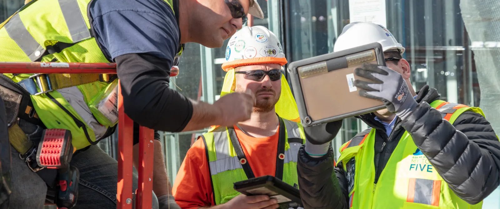 Construction Collaboration - Construction team on site with tablet.