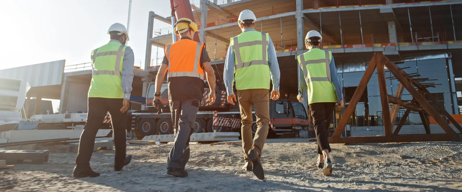 Members of a construction team walking on project site for Construction Software Administration.