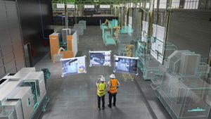 two workers looking at construction screens