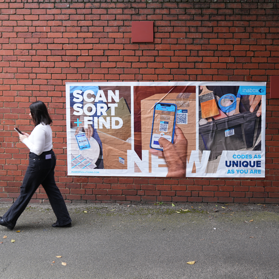 Girl walking pass organised by inabox mobile app posters on an Australian street