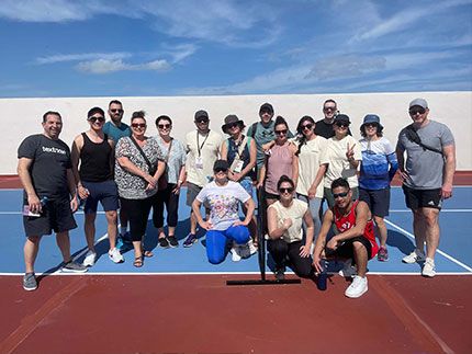 Legal, IT and finance teams on volleyball court