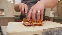 Chef Alex Chen preparing a Truffle Mortadella Grilled Cheese in a modern kitchen setting at Trail Appliances Richmond Showroom - Sub-Zero Wolf kitchen