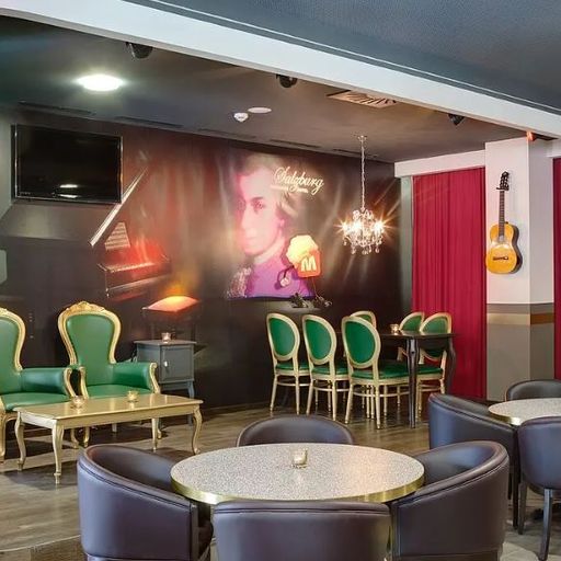 A stylish bar with red velvet curtains, vintage chairs, a mural of a composer, and a guitar on the wall; intimate and classic ambiance.