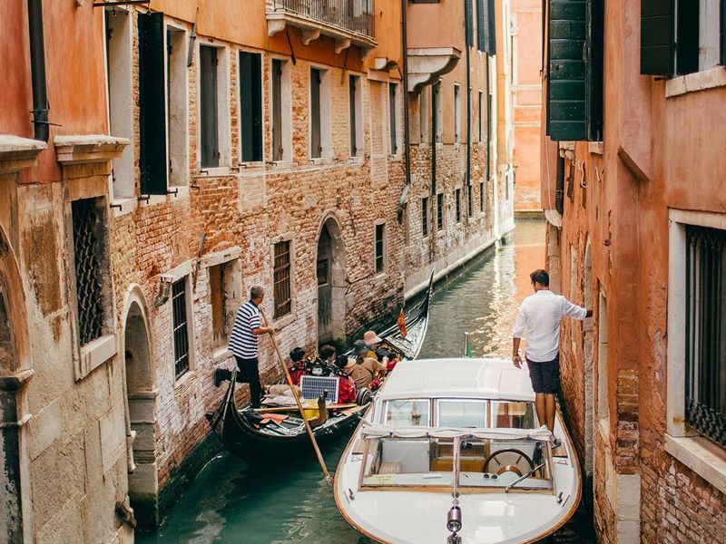 Boats in a narrow Venetian canal