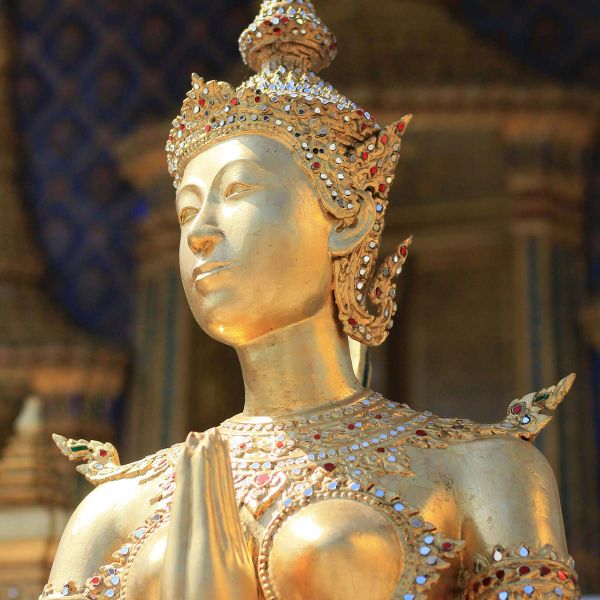 A close-up of a gold Buddha statue in Thailand.