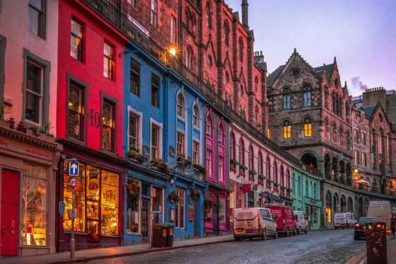 A row of colorful buildings on a cobblestone street