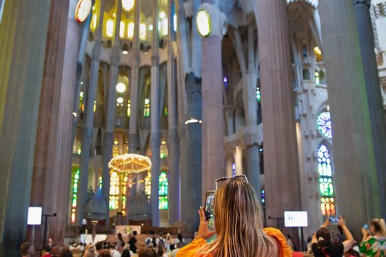 A person taking a picture in the middle of a church.