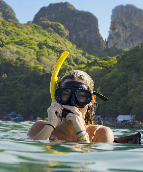 A person in a snorkel mask in the water