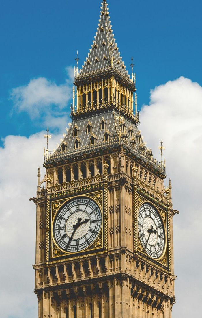 The Elizabeth Tower, commonly known as Big Ben, against a blue sky with white clouds.
