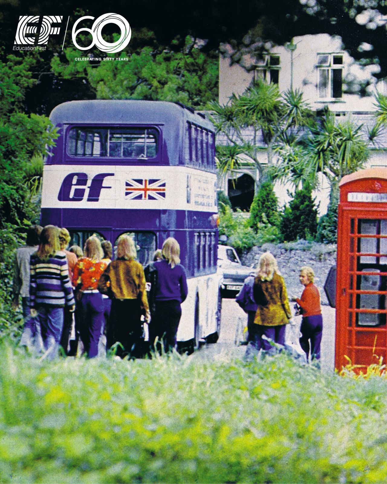 Two women joyfully take a selfie on a rooftop, with a mosque in the background and a dramatic cloudy sky. Birds fly around at sunset.