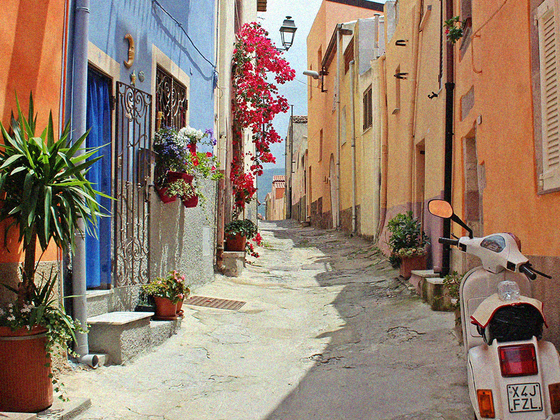 Narrow cobblestone alley with colorful buildings, vibrant flowers, and a parked white scooter under a street lamp.