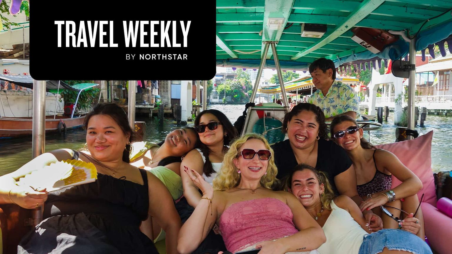 Group of people smiling on a boat under a teal canopy, with a "Travel Weekly by Northstar" logo in the top left corner.