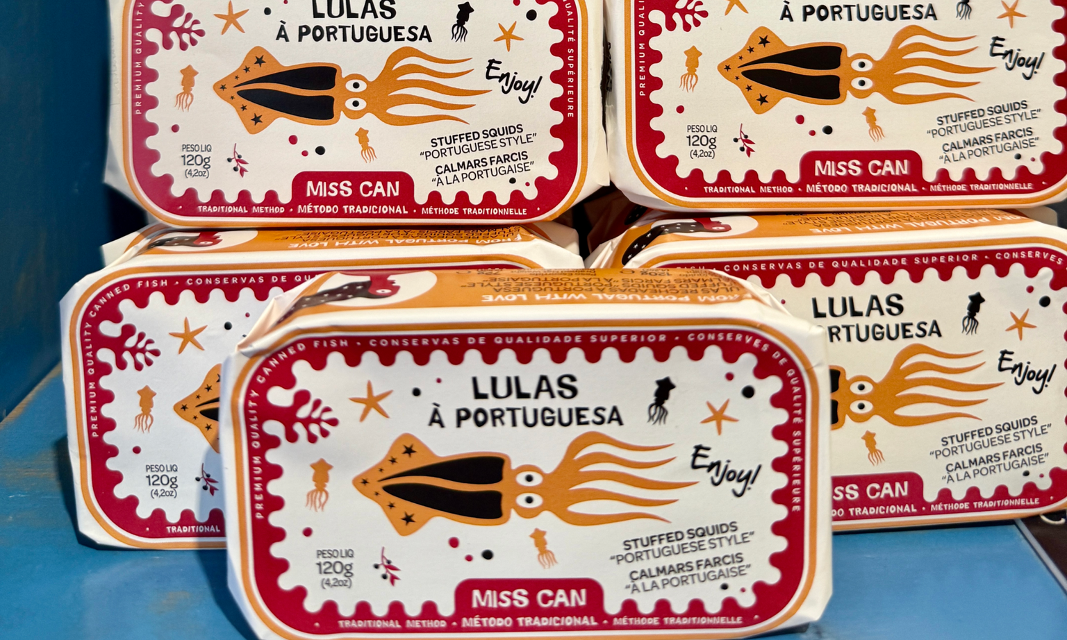 Tins of squid stacked onto each other.