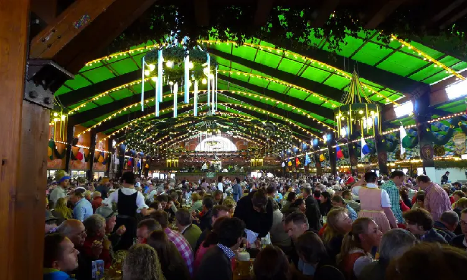 Inside the Augustiner-Festhalle tent with people sitting at tables.