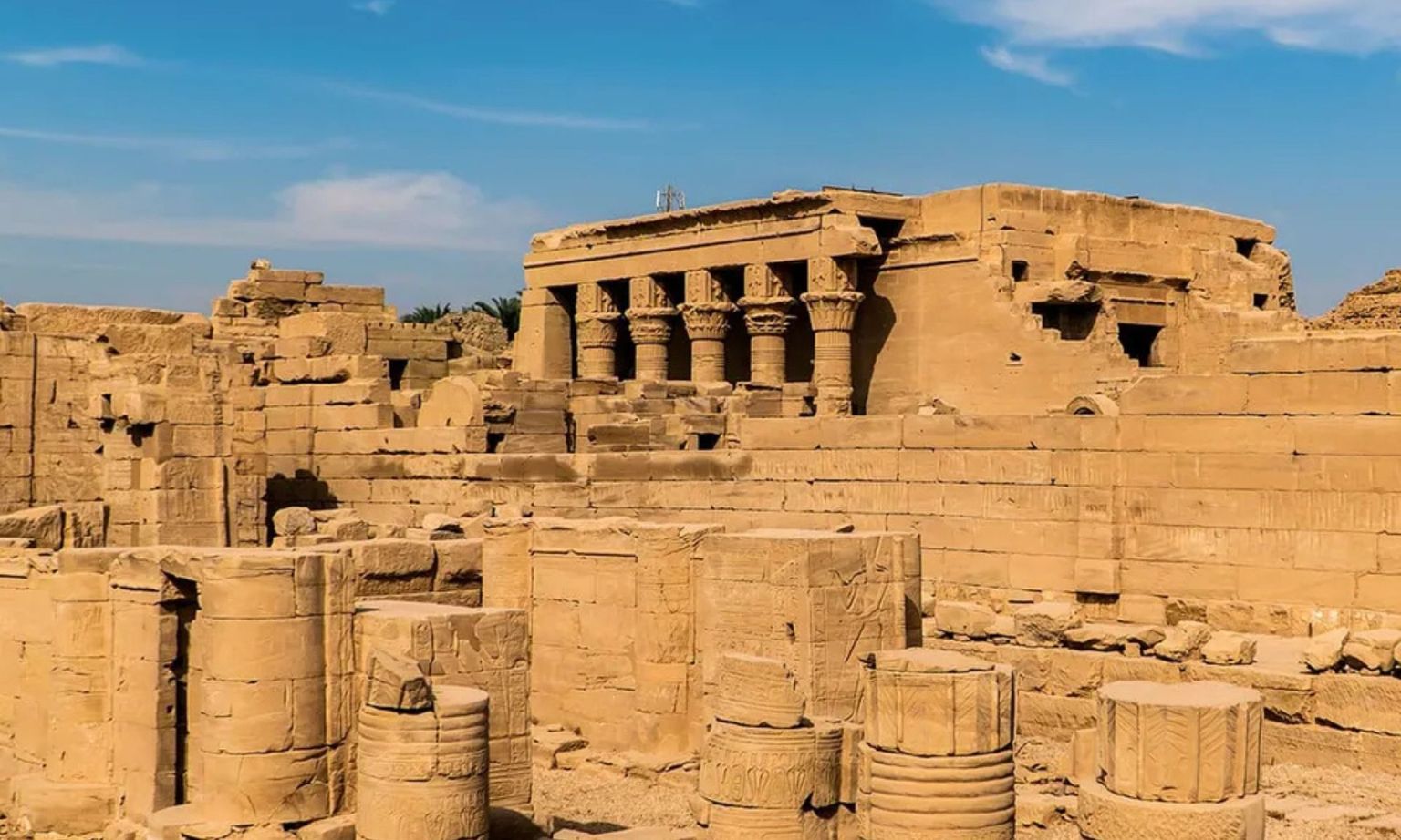 The ruins and columns of a stone Egyptian temple