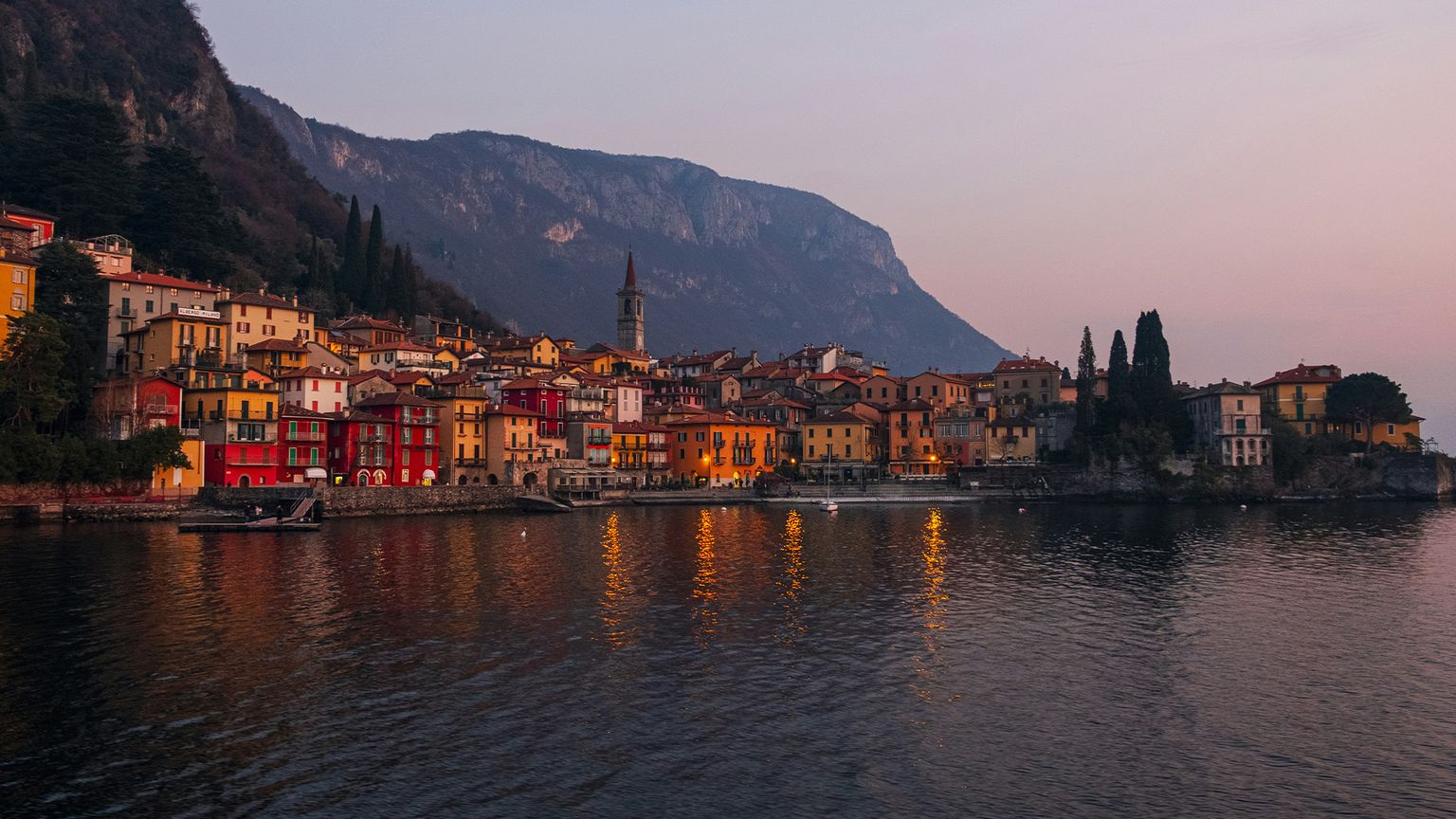 Mountains and the city of Varenna at sunset on the edge of Lake Como, Italy
