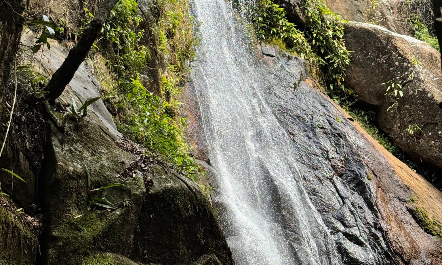 A close-up of a roaring, rocky waterfall
