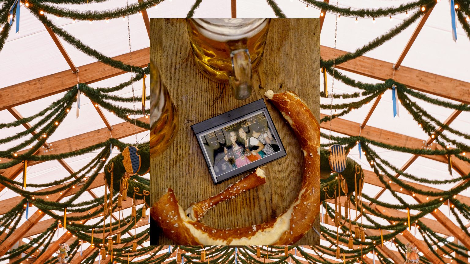 A table with a stein, a pretzel, and a photo of two women holding steins.