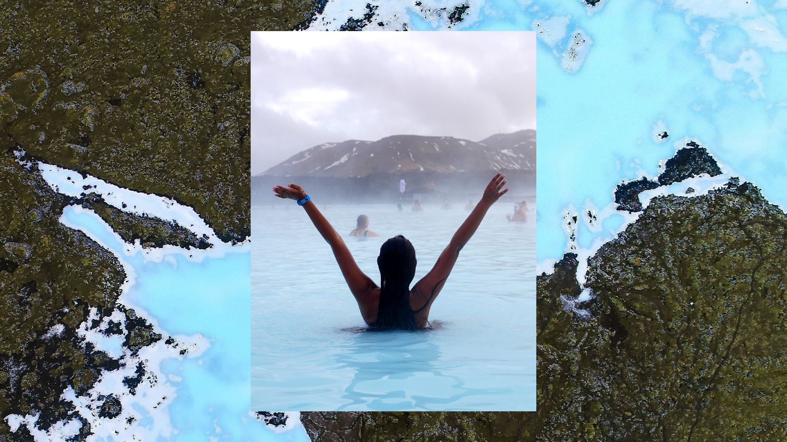 A woman posing for a picture away from the camera while in the Blue Lagoon.