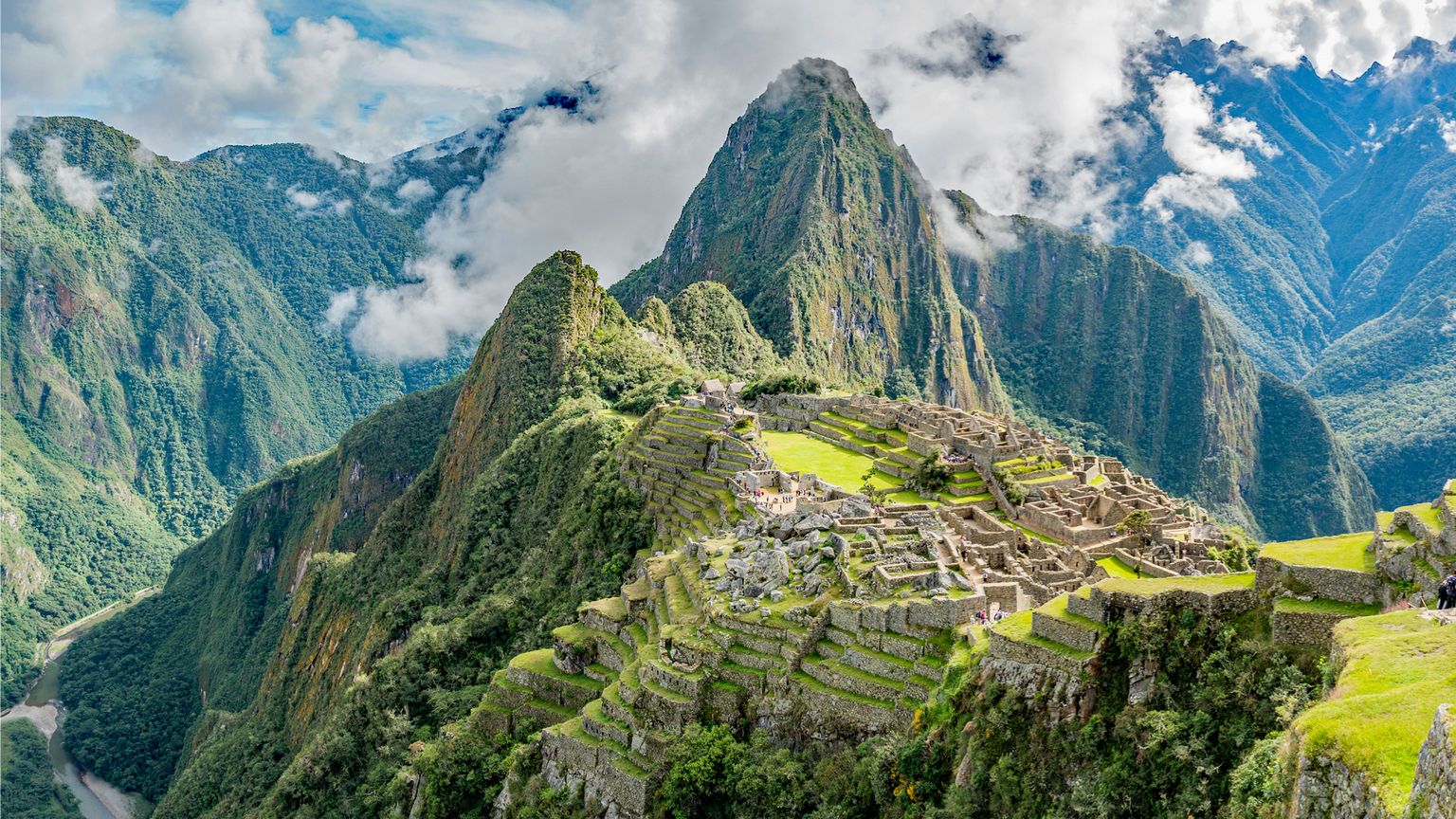 An aerial photo of Macchu Picchu and the surrounding Andes Mountain range in Peru