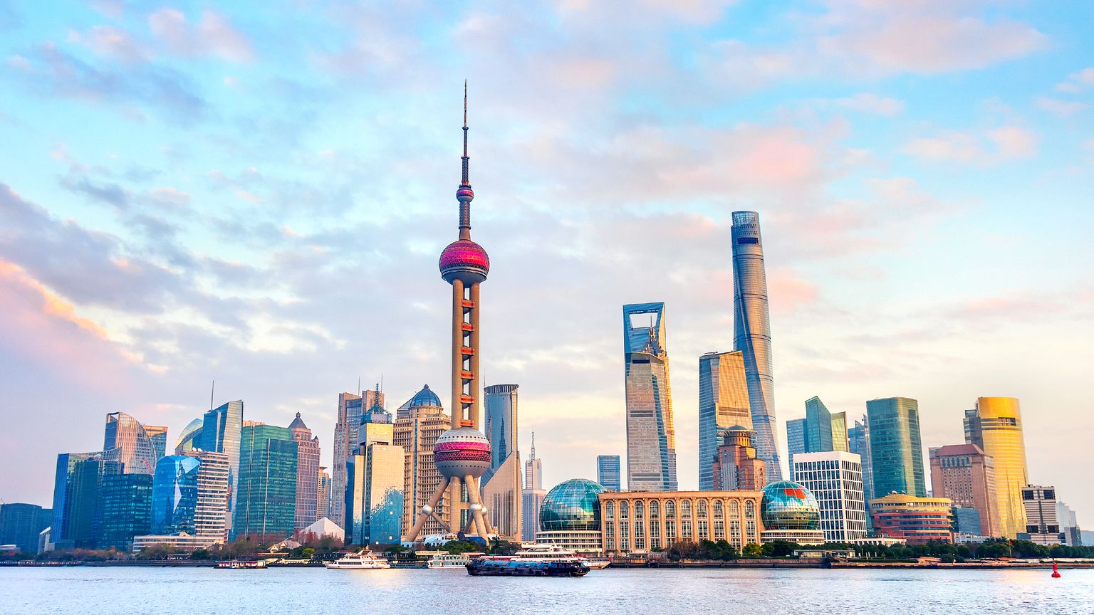 A tower, skyscrapers, and riverfront of the skyline of Shanghai