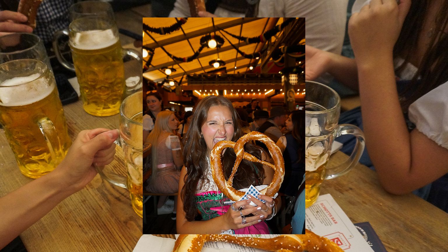 A woman taking a bite out of a pretzel during Oktoberfest in Germany.