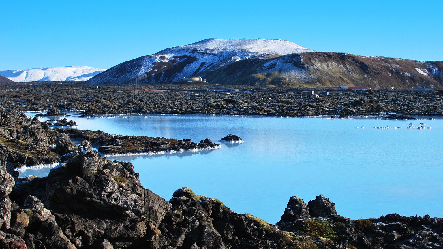 The Blue Lagoon with mountains in the background.