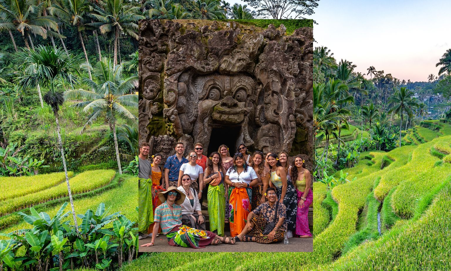 A group of people poses in front of an ancient stone carving, surrounded by lush green rice terraces and palm trees.