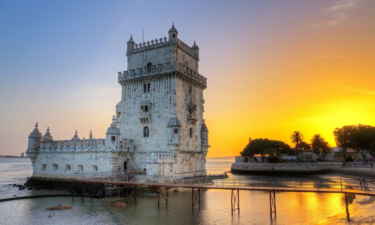 Lisbon's iconic stone Belém Tower on the Tagus River at sunset