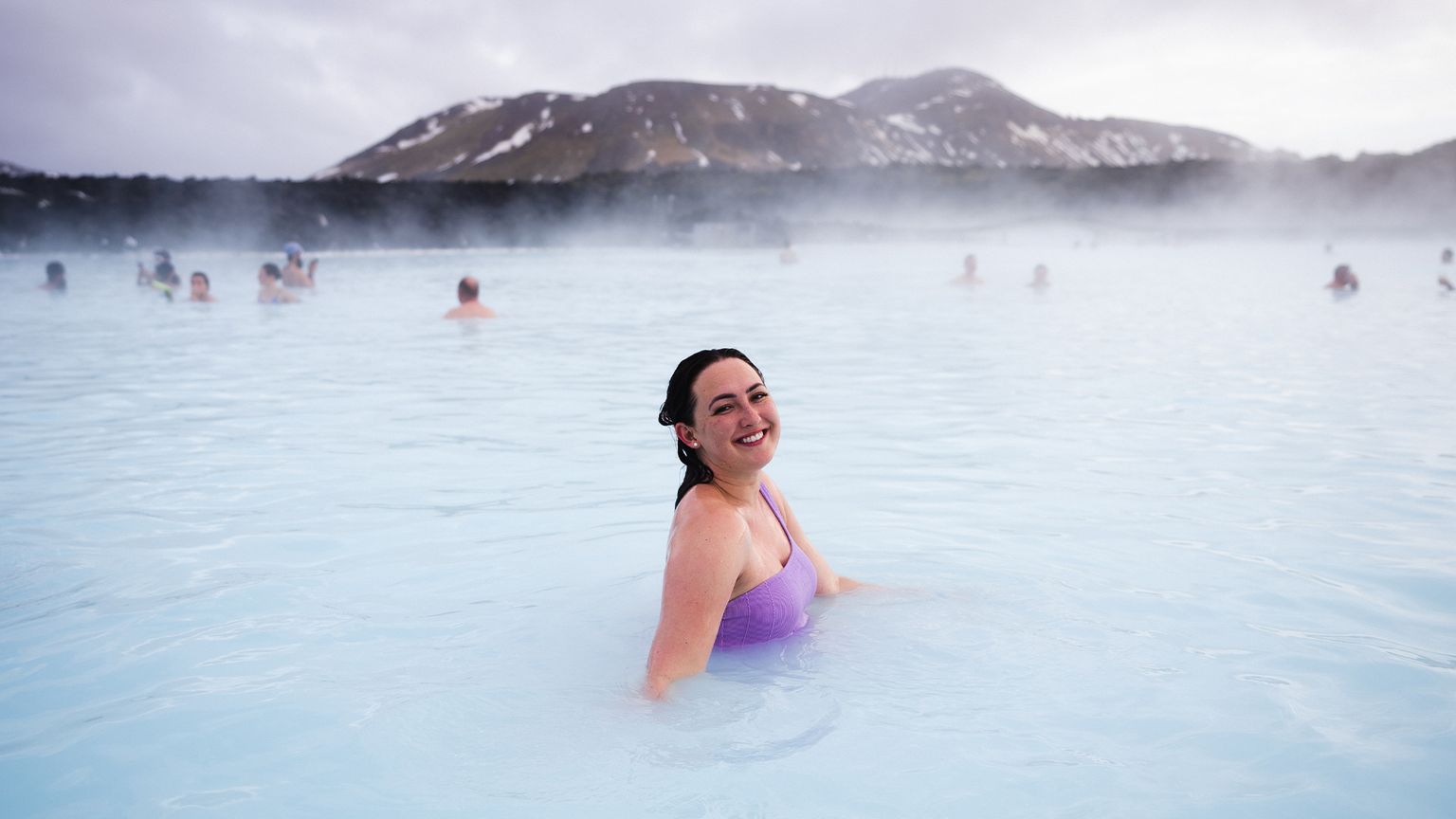 A woman posing for a picture in the Blue Lagoon.