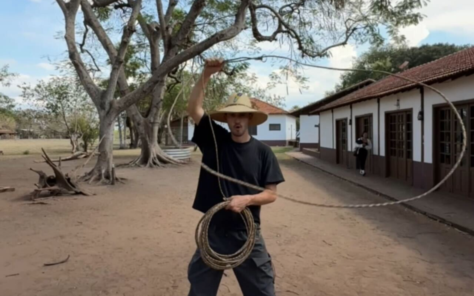 A man in a wide-brimmed hat throwing a lasso on a farm in Brazil's Pantanal