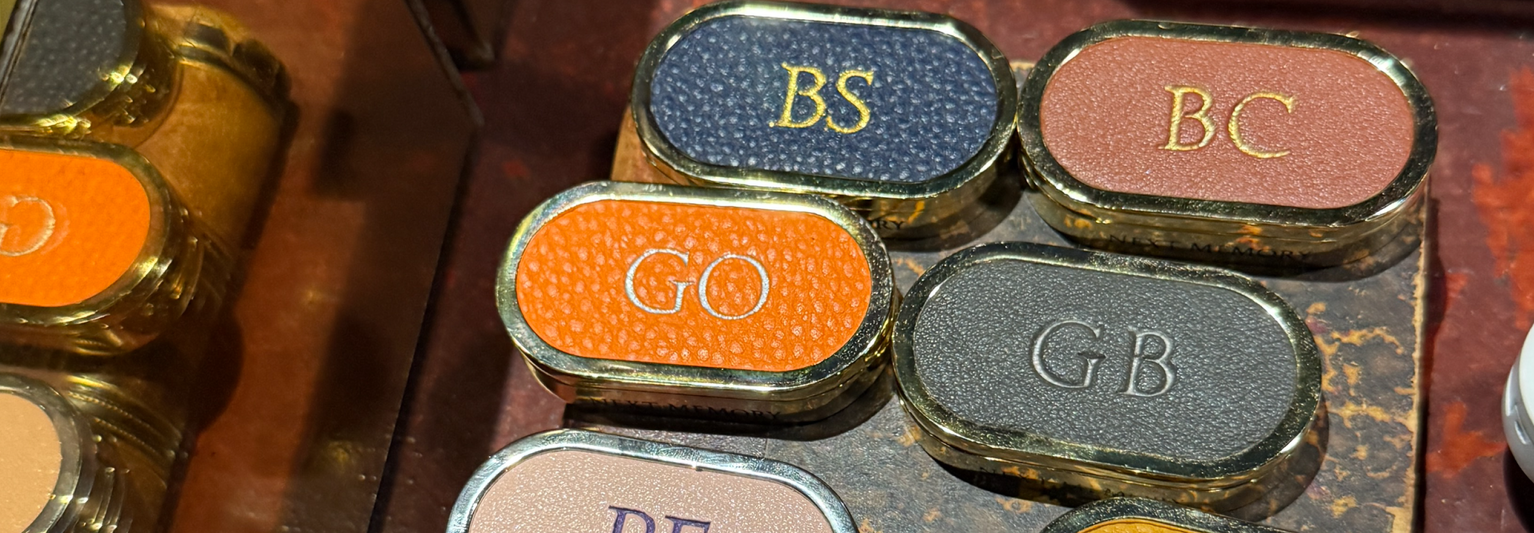 Multicolored leather and gold solid perfume cases with monogrammed initials