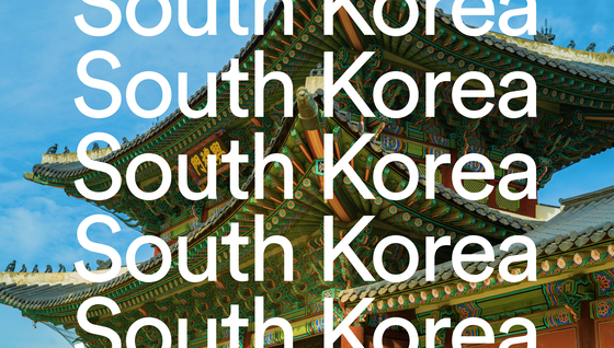 Traditional Korean temple roof with intricate designs under a blue sky, overlaid with repeated text "South Korea."