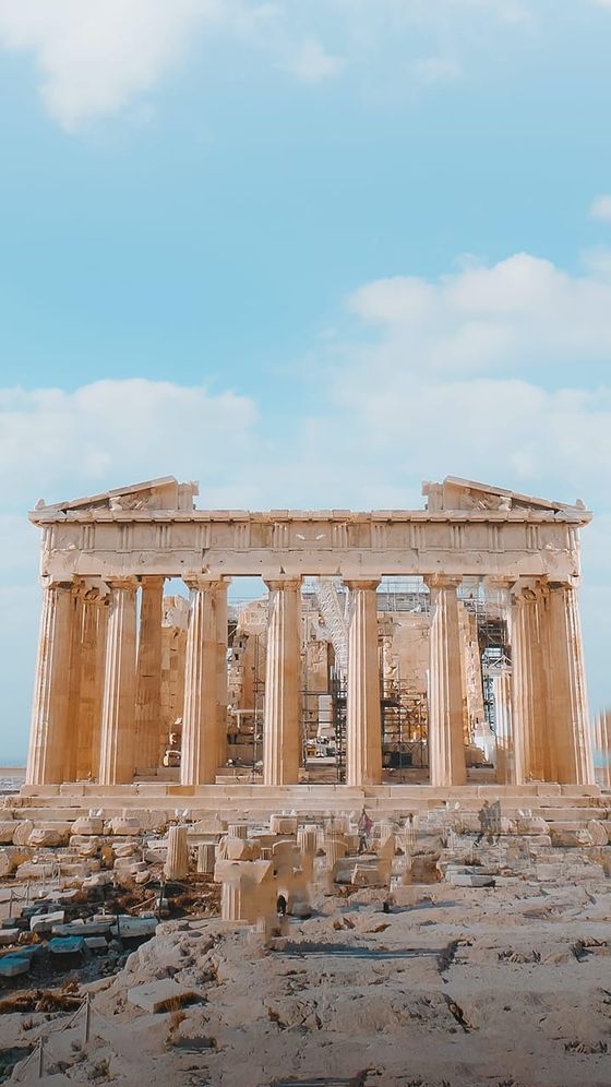 The Parthenon under a clear blue sky, showcasing its iconic columns and ancient stone architecture.
