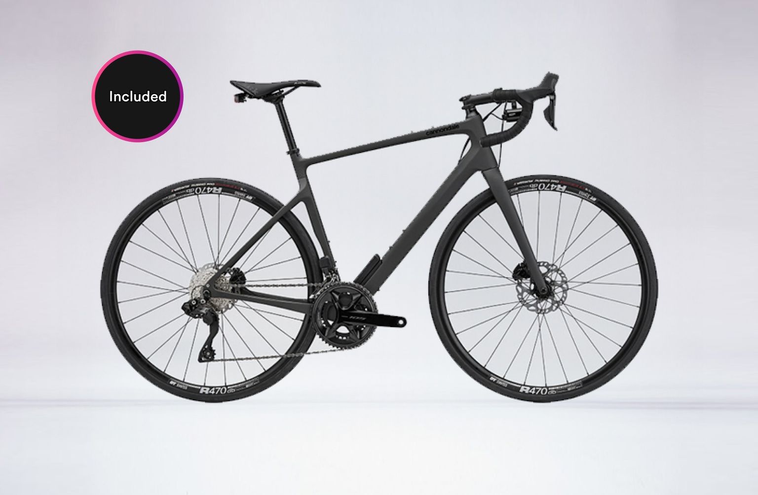 Sleek black road bike with disc brakes and drop handlebars against a light gray background. A circular "Included" badge is on the top left.