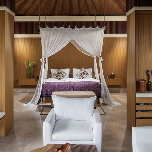 Luxurious bedroom with a canopy bed, white sofas, wooden walls, and elegant decor. Neutral tones create a serene and inviting atmosphere.