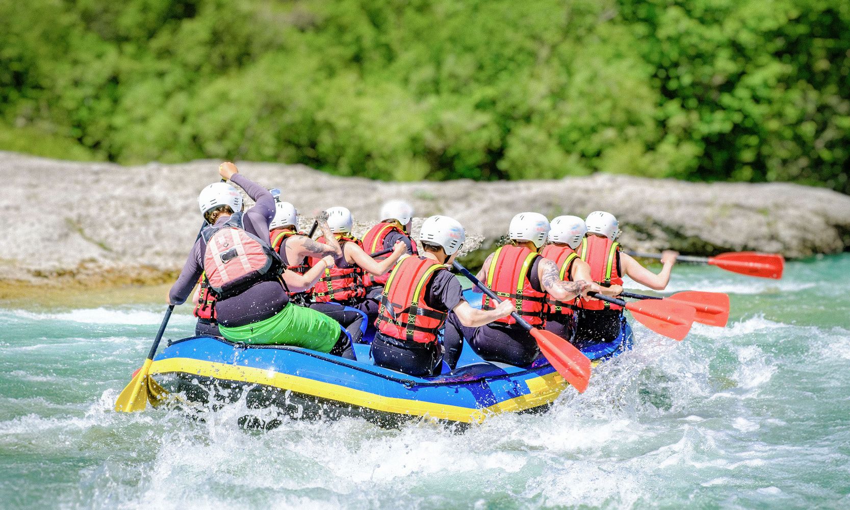 A group of eight whitewater rafting o the Saalach River in Austria.