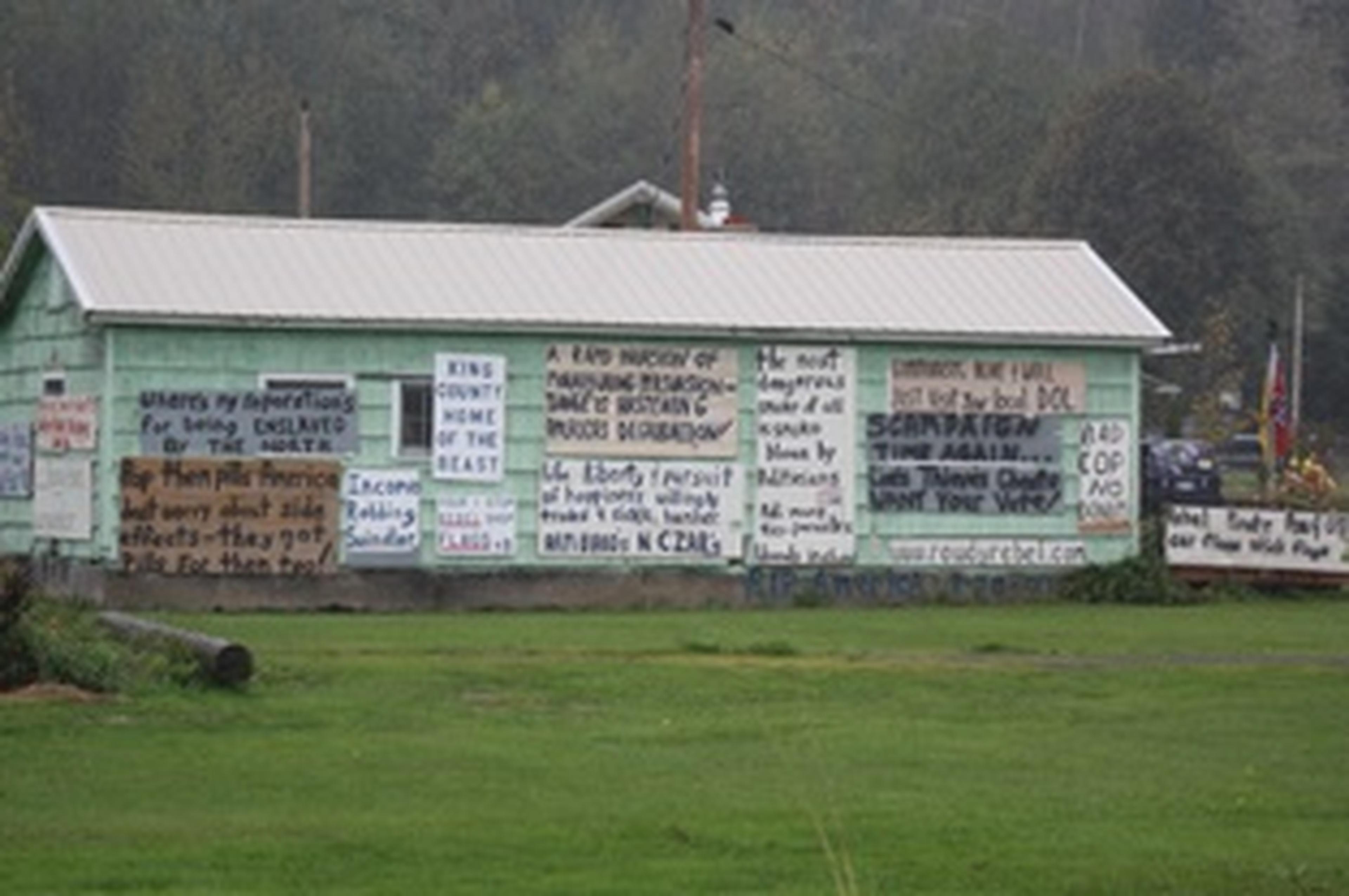 green house with writing on the side of it