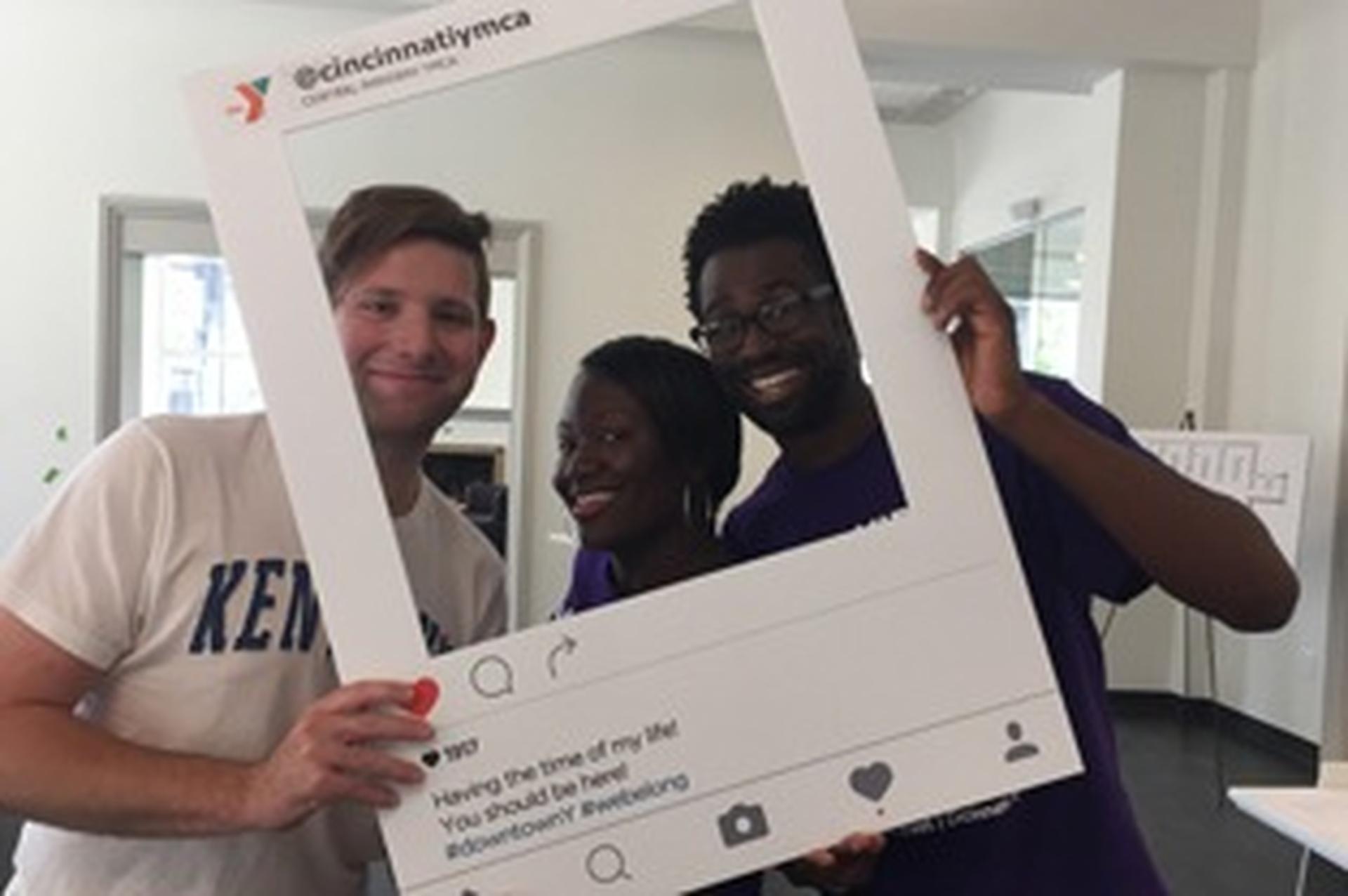 YMCA photo frame prop with people posing in it