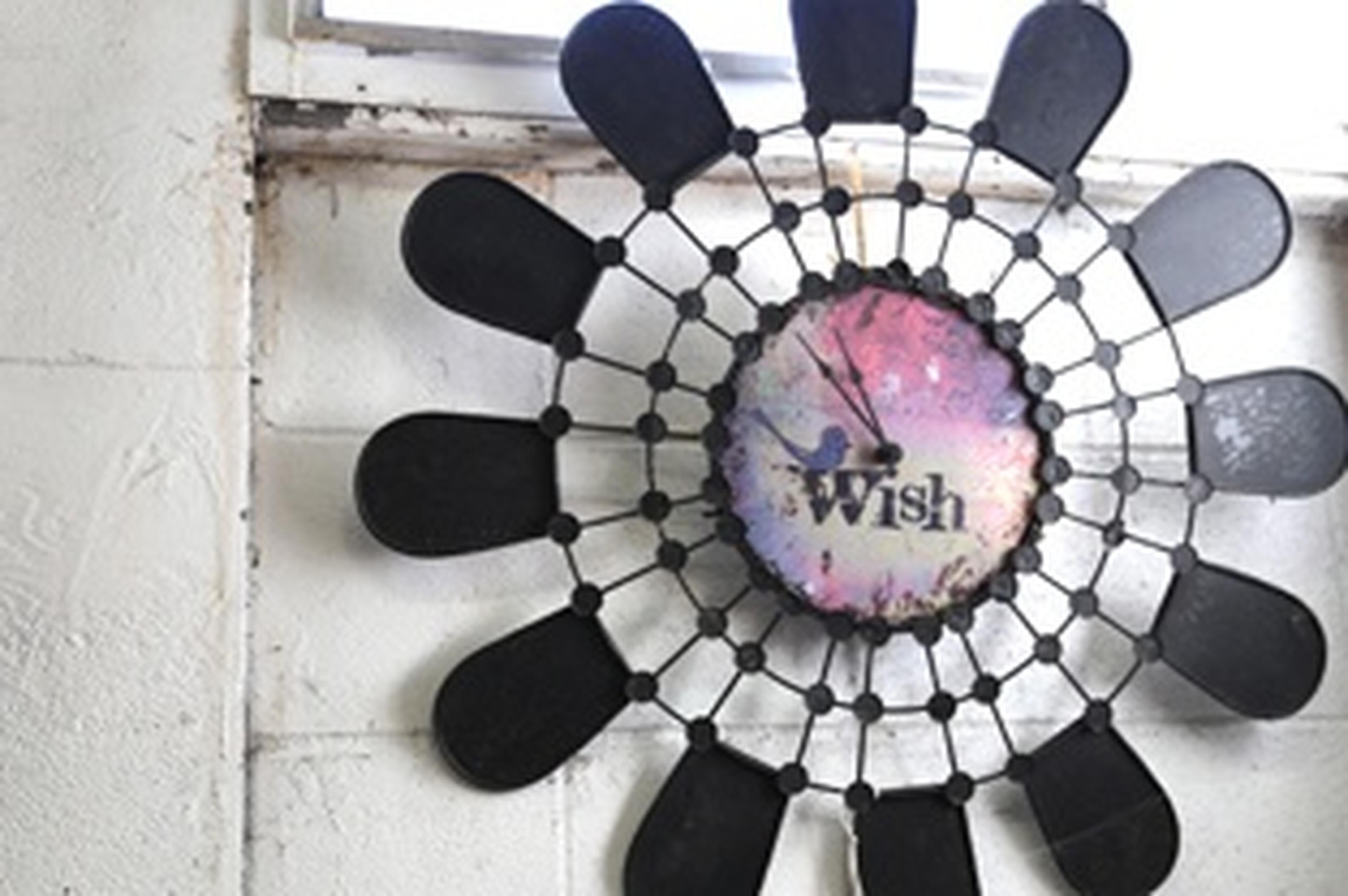 black abstract flower clock with "wish" in the middle