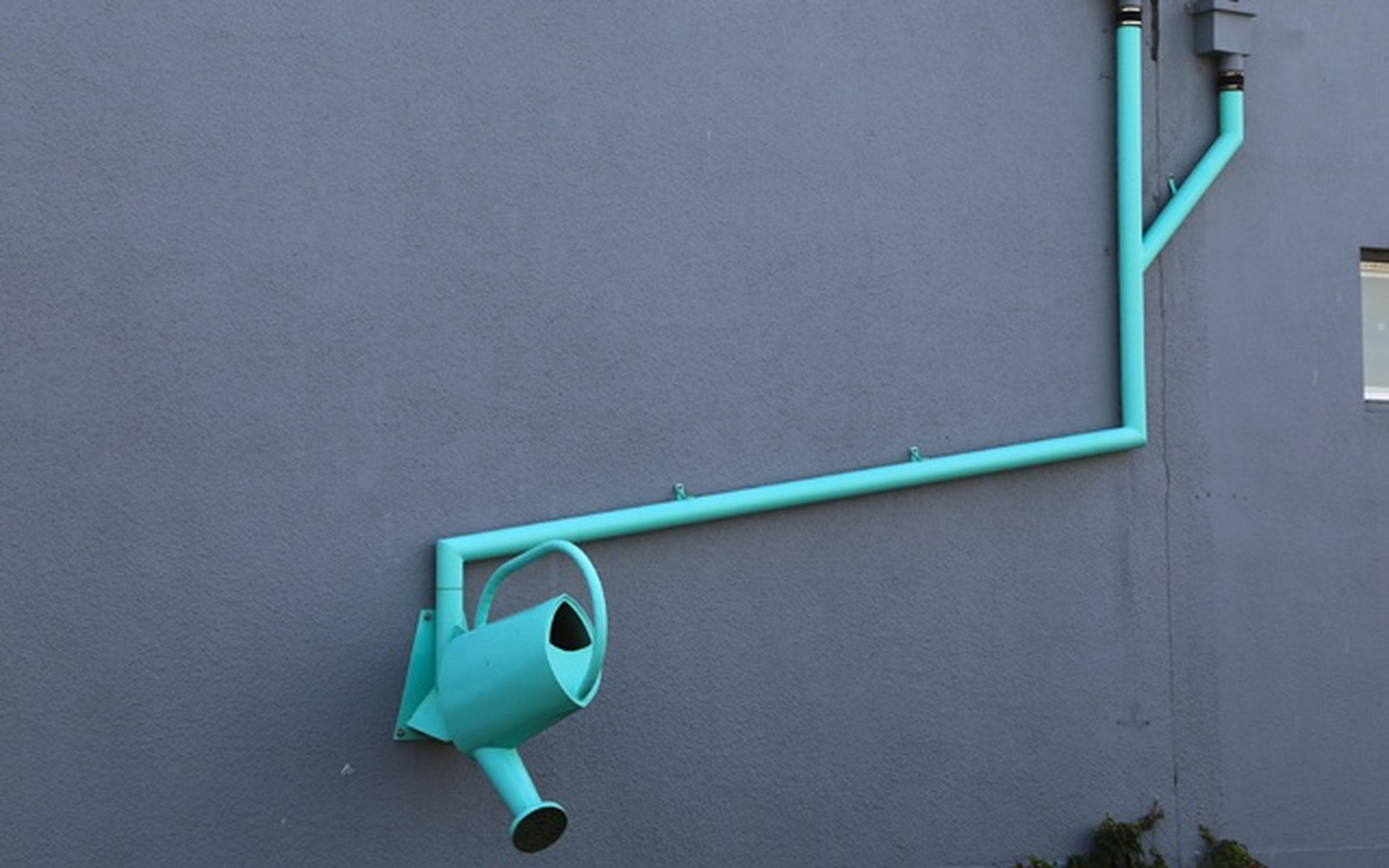 blue pipes with watering can on the end