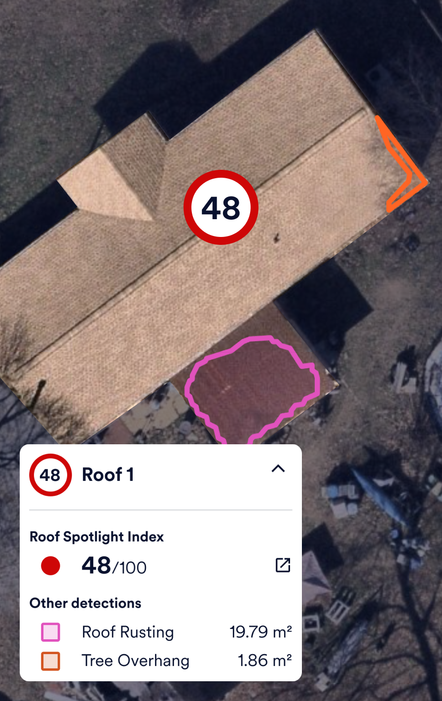 Image of roof damage on residential home, with AI-detected roof scoring
