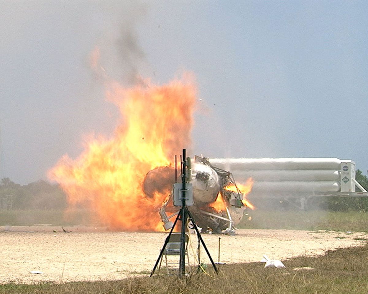 The Morpheus Alpha lunar lander prototype, crashed on a test pad and completely on fire.