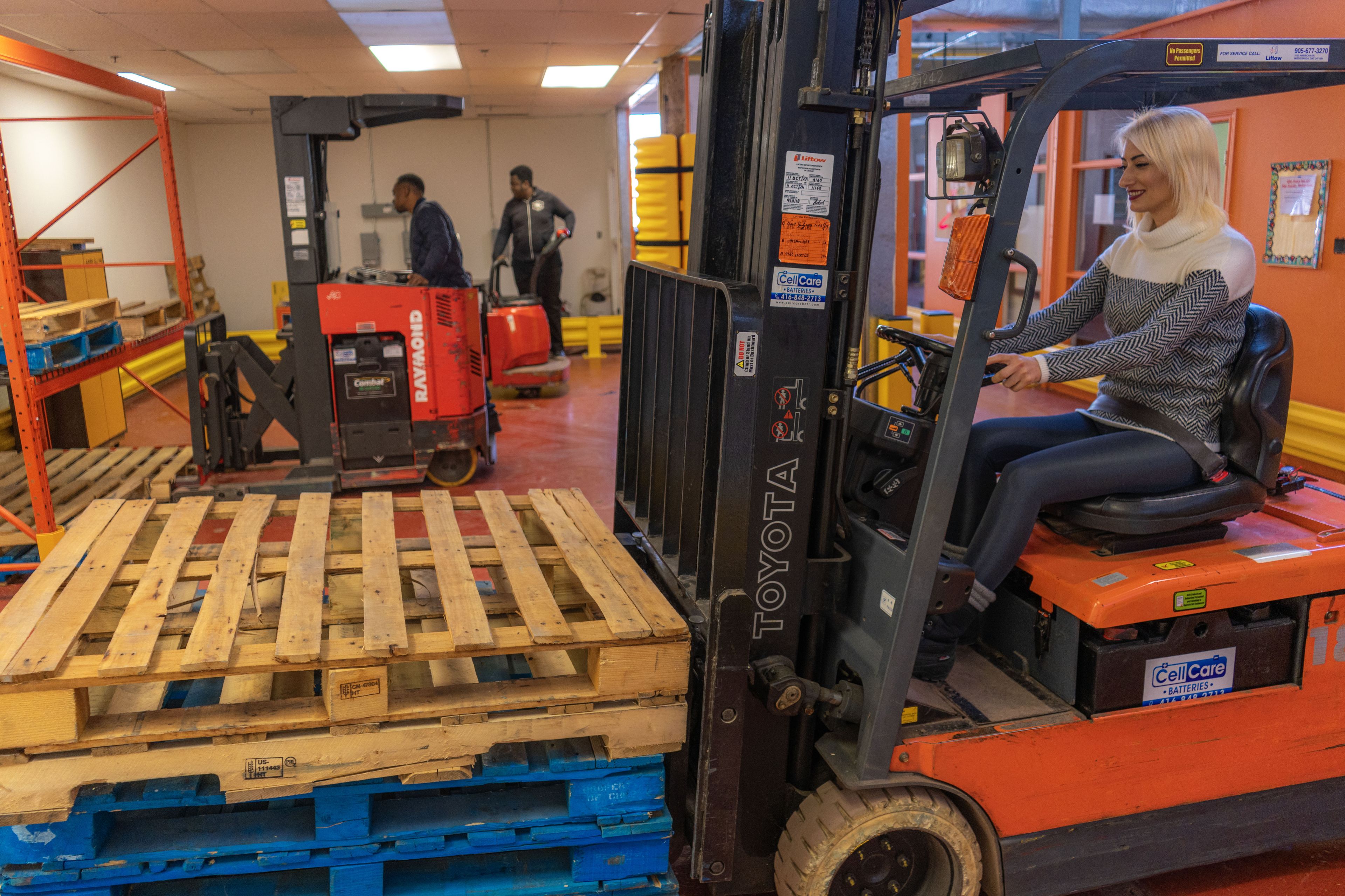 A person driving a fork lift.