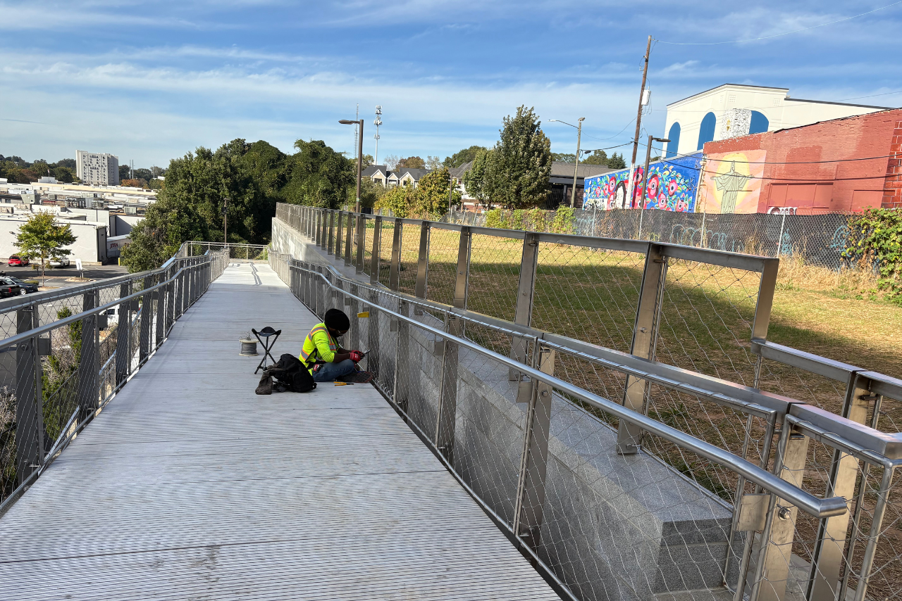 Installing stainless steel cable mesh on the Ponce ramp guardrail. (Photo Credit: ABI Staff)