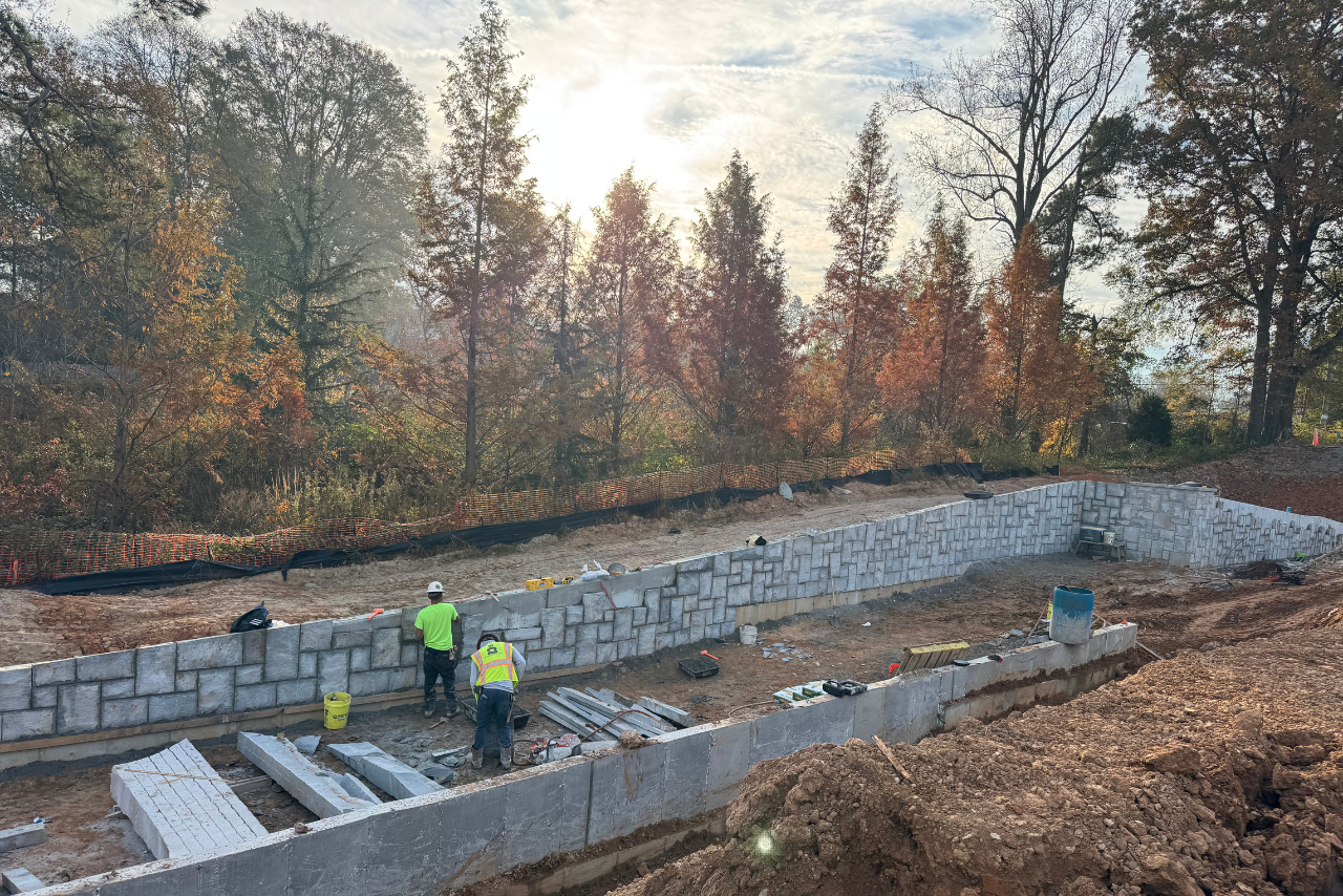 Retaining walls with granite cladding in progress. (Photo Credit: ABI Staff)