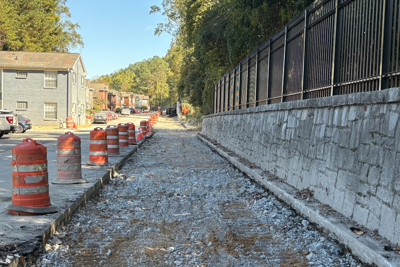 Removal of asphalt road to narrow road and make room for the trail and landscape buffer. (Photo Credit: ABI Staff)