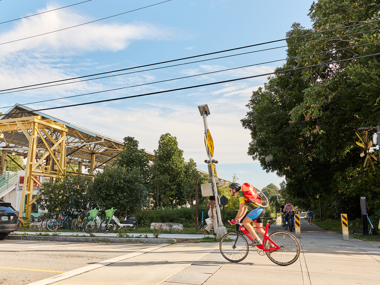 A man rides his bike past the entrance to the Atlanta Beltline's Southeast Trail.