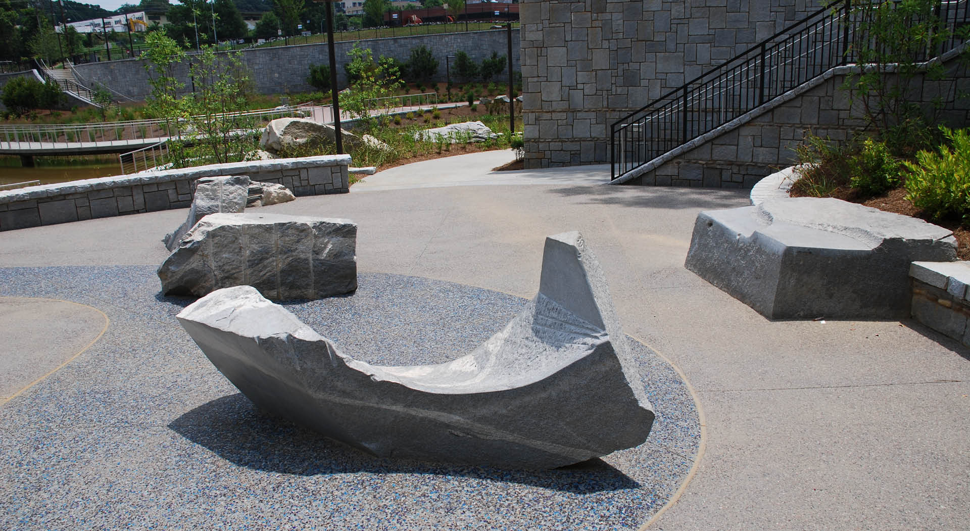 Curving granite sculptures made for seating by Maria Artemis.